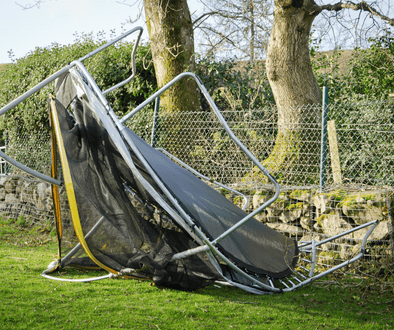 An image of a blown away trampoline. GroundGrabba ground anchors can prevent this from happening. 