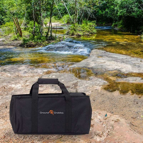 The GroundGrabba carry all bag next to a stream. 